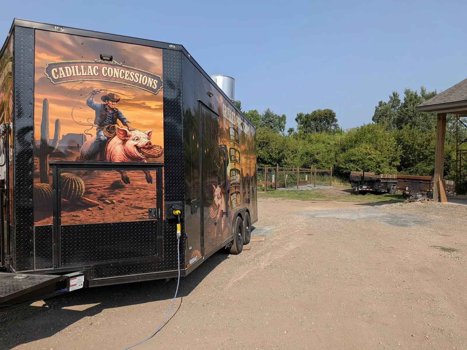 Western-themed concession trailer wrap viewed from the rear